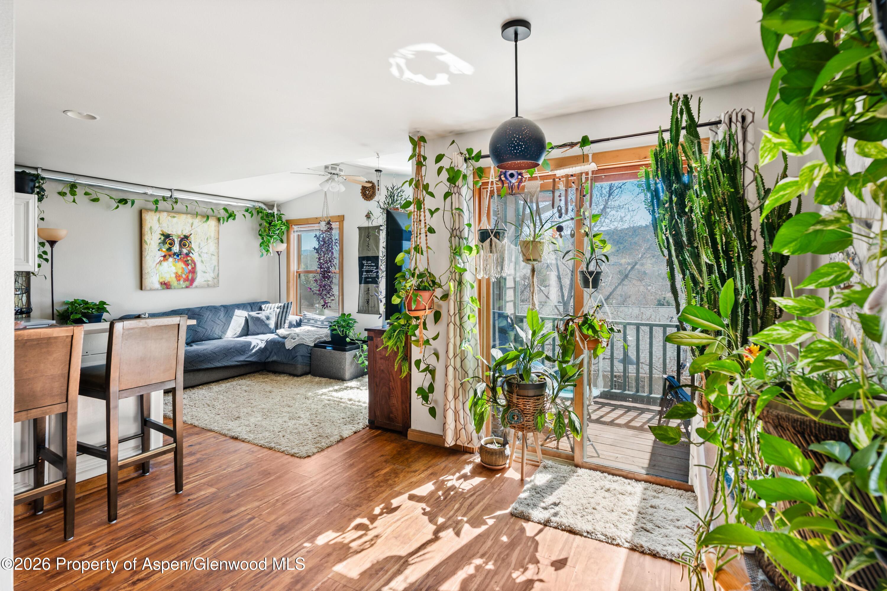 682 Alder Ridge Lane New Castle, CO 81647 - Photo 3 of 19 a room with lots of potted plants and wooden floor