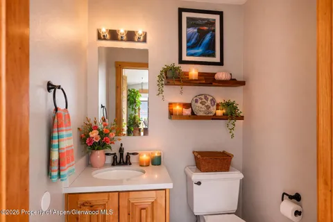 a bathroom with a toilet sink and mirror