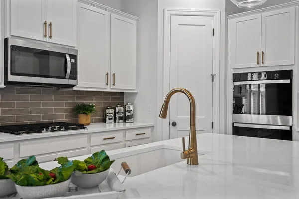 a kitchen with a stove and a microwave