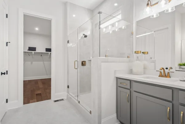 a bathroom with a shower sink and mirror