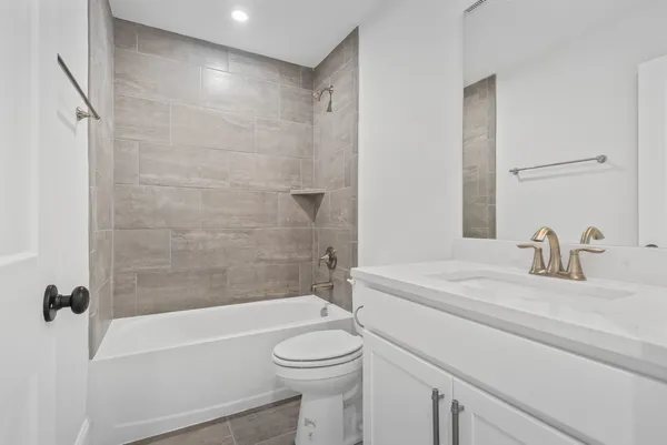 a bathroom with a sink a toilet and a bathtub