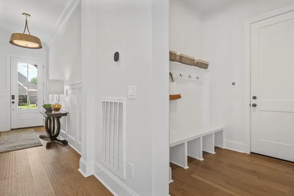 a view of a hallway with wooden floor and dining room