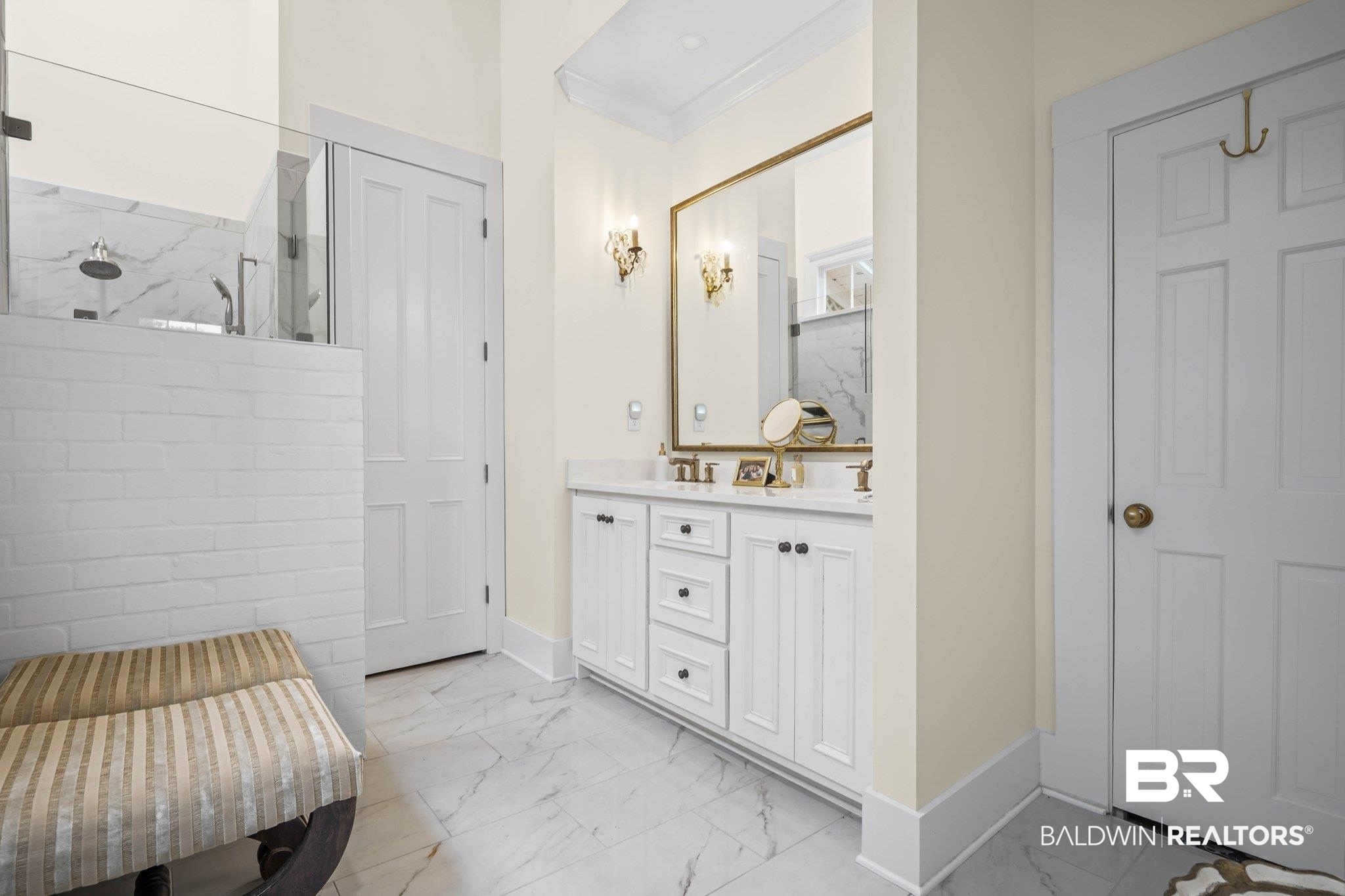 23561 Main Street Fairhope, AL 36532 - Photo 23 of 45 Full bath featuring light marble finish floors, double vanity, a marble finish shower, and ornamental molding