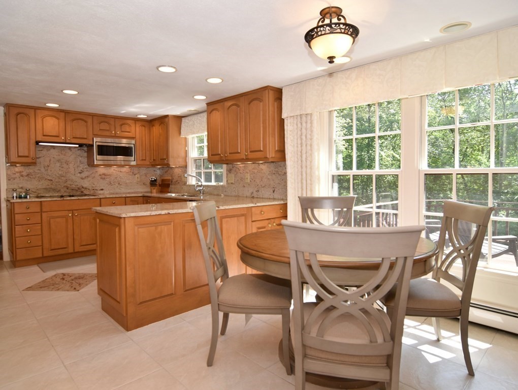 3 Violet Circle Milford, MA 01757 - Photo 3 of 41 a kitchen with a table chairs sink and cabinets