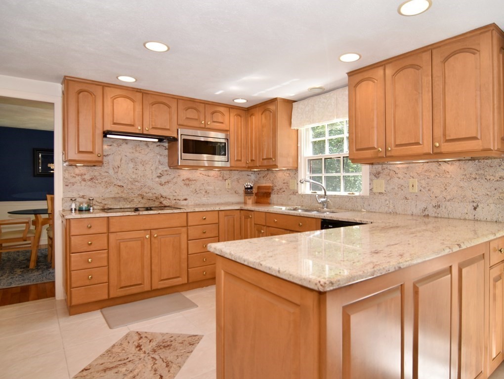 3 Violet Circle Milford, MA 01757 - Photo 6 of 41 a kitchen with a sink stove and cabinets