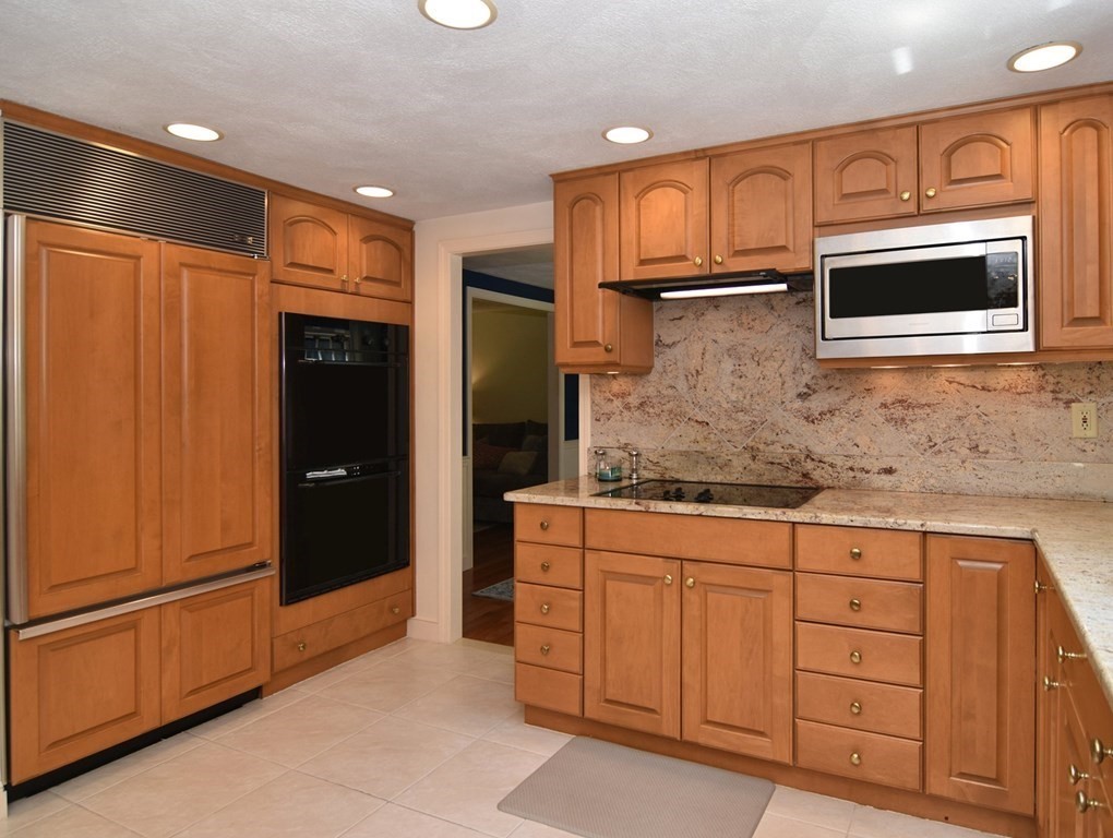 3 Violet Circle Milford, MA 01757 - Photo 7 of 41 a kitchen with stainless steel appliances granite countertop a refrigerator and a stove top oven