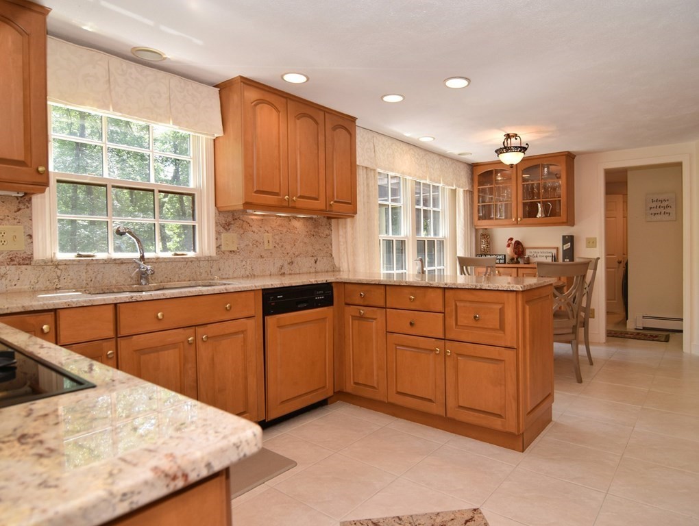 3 Violet Circle Milford, MA 01757 - Photo 9 of 41 a kitchen with stainless steel appliances kitchen island granite countertop a sink and cabinets