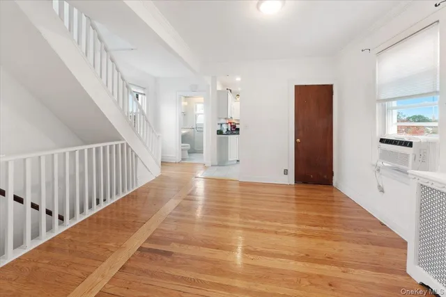 a view of a hallway view with wooden floor and staircase
