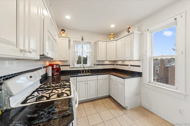 a kitchen with stainless steel appliances a sink stove and cabinets