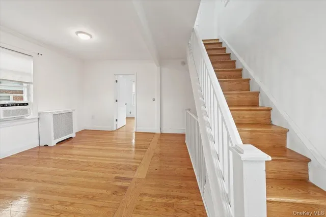 a view of a room with wooden floor and stairs