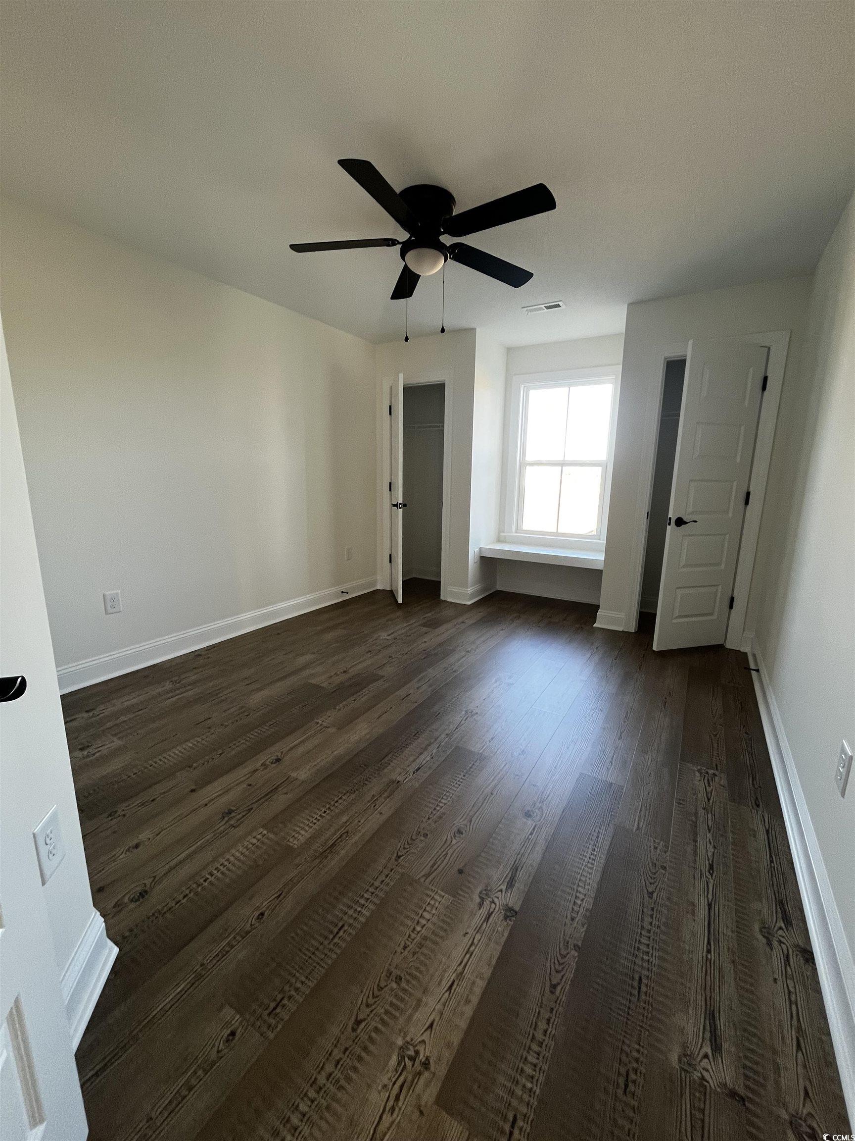3440 Asbury Road Aynor, SC 29511 - Photo 6 of 9 Unfurnished bedroom with a ceiling fan, dark wood-style flooring, and a closet