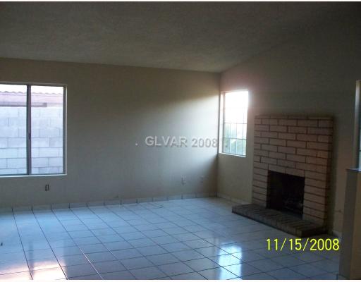 5500 Liverpool Road Las Vegas, NV 89107 - Photo 2 of 7 Living Room. freshly painted - charming brick fireplace