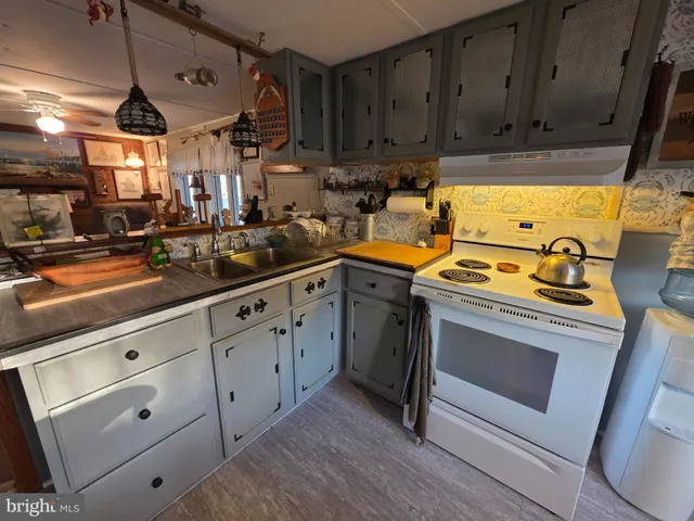 a kitchen with appliances cabinets and a sink
