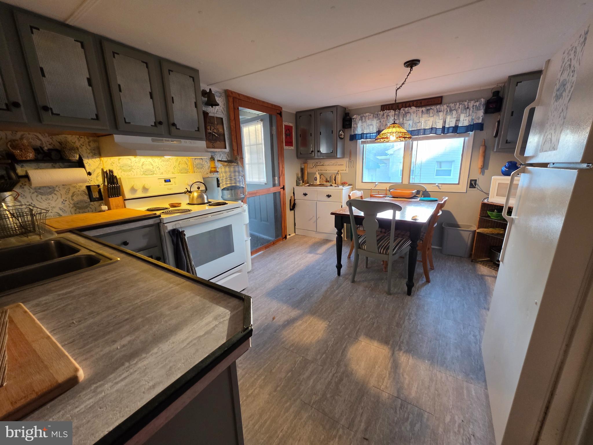 21 Vassar Avenue Fortescue, NJ 08321 - Photo 17 of 44 a kitchen with wooden floors and wooden cabinets