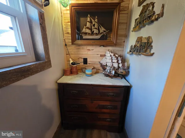 a room with wooden floor washer and dryer