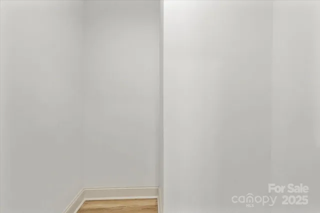 a view of a kitchen with wooden floor and a sink