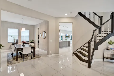 a kitchen with stainless steel appliances kitchen island granite countertop a sink and a refrigerator