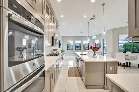 a bedroom with a bed a couch and a flat tv screen on the dresser