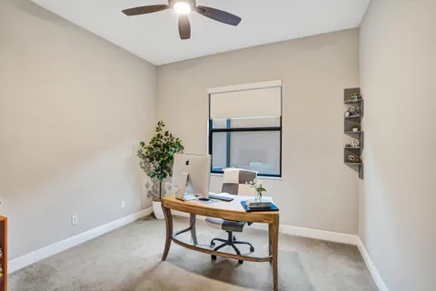 a living room with furniture a chandelier and a large window