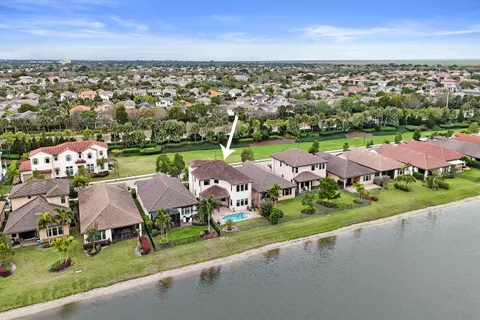 a view of a house with pool table and chairs
