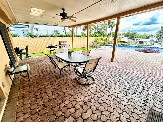 a view of a porch with furniture and a yard