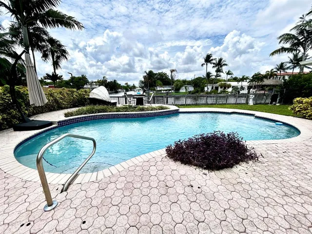 a view of a swimming pool and lounge chair