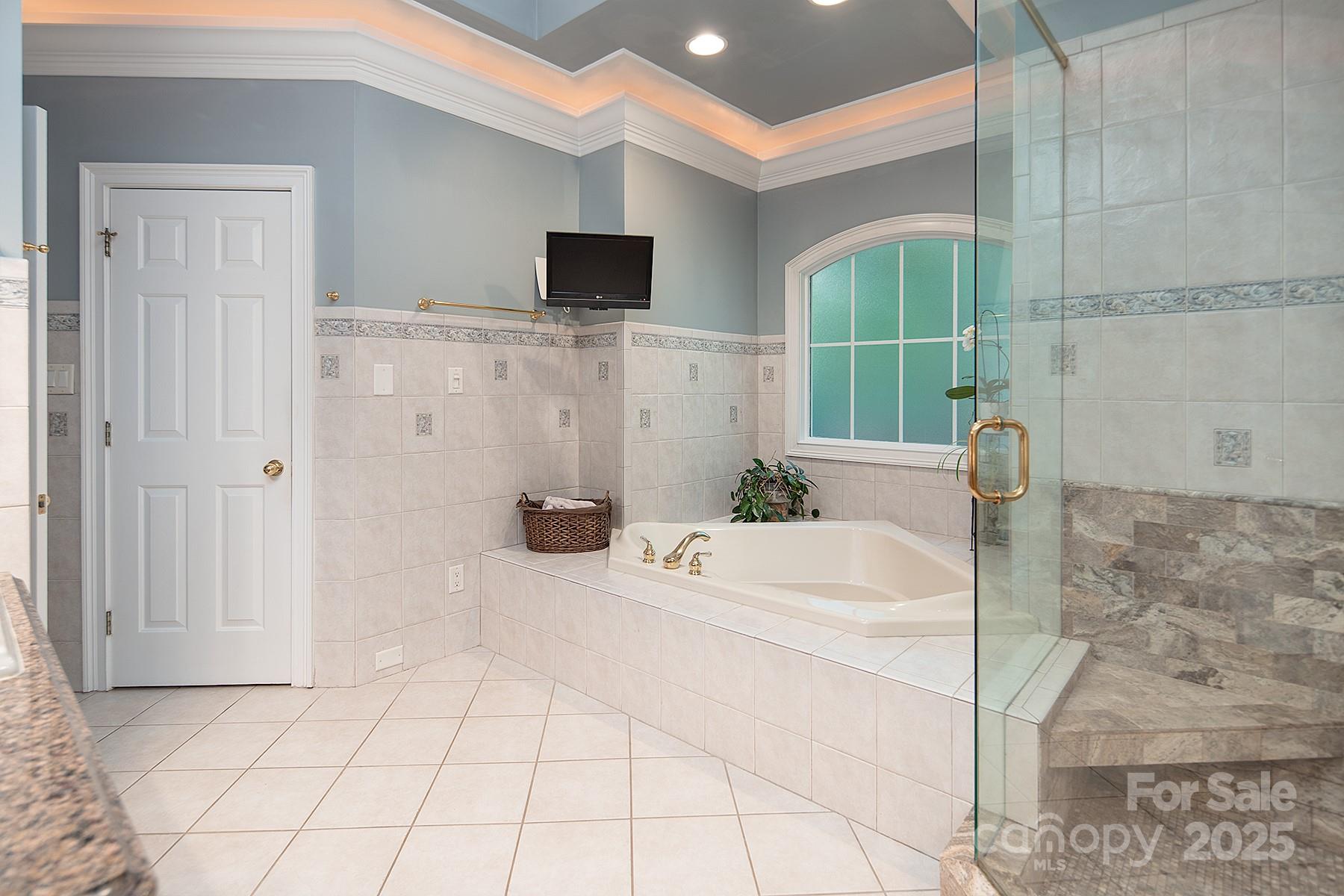 3504 High Ridge Road Charlotte, NC 28270 - Photo 18 of 36 a bathroom with a tub a mirror and shower