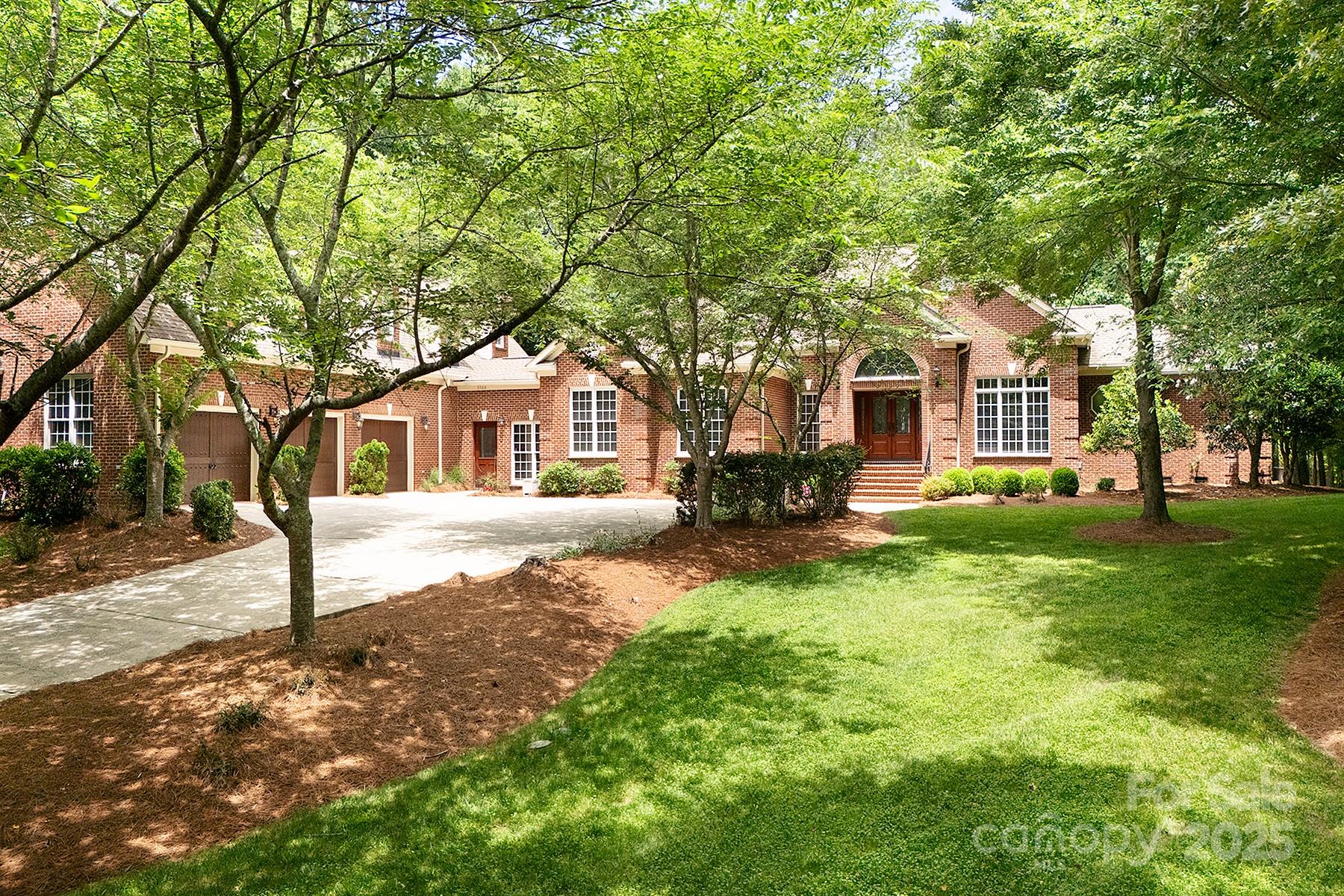 3504 High Ridge Road Charlotte, NC 28270 - Photo 2 of 36 a front view of a house with a garden and trees