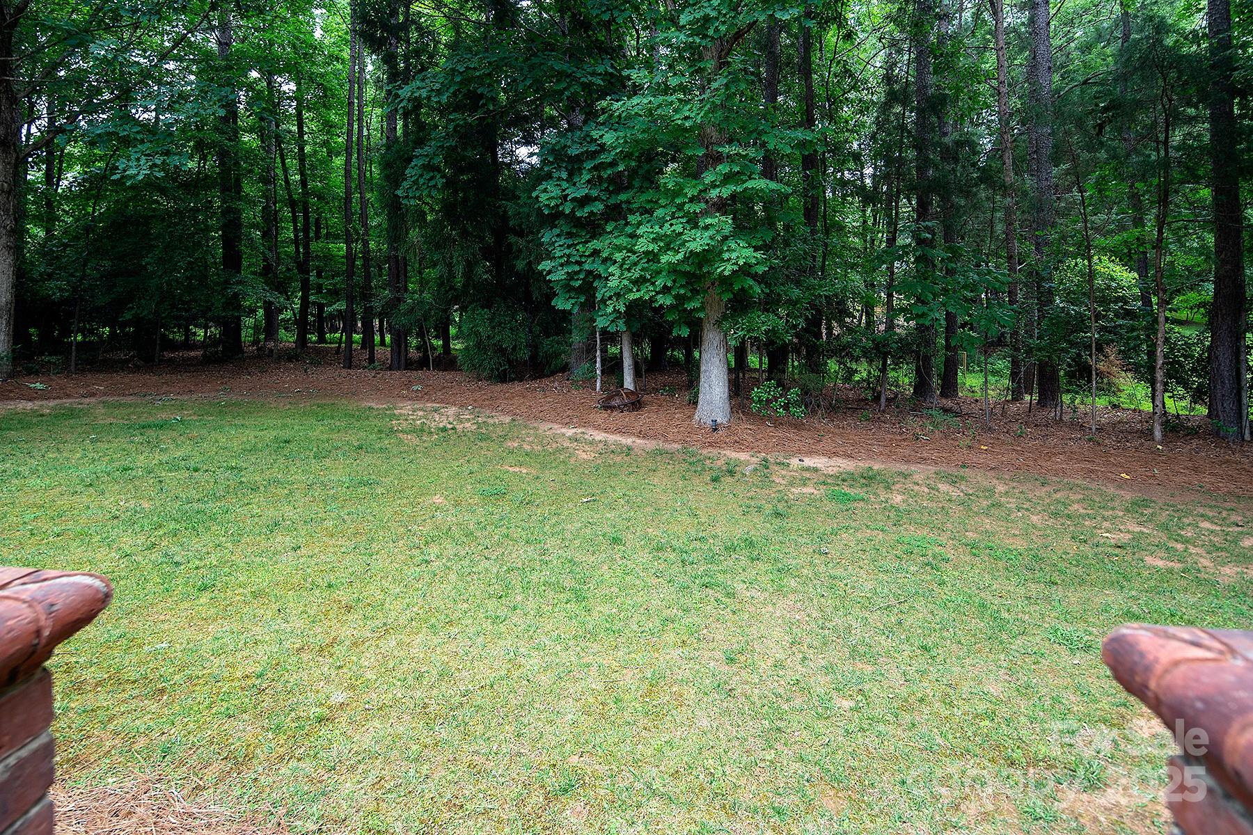 3504 High Ridge Road Charlotte, NC 28270 - Photo 34 of 36 a view of a backyard with table and chairs a barbeque and a large trees