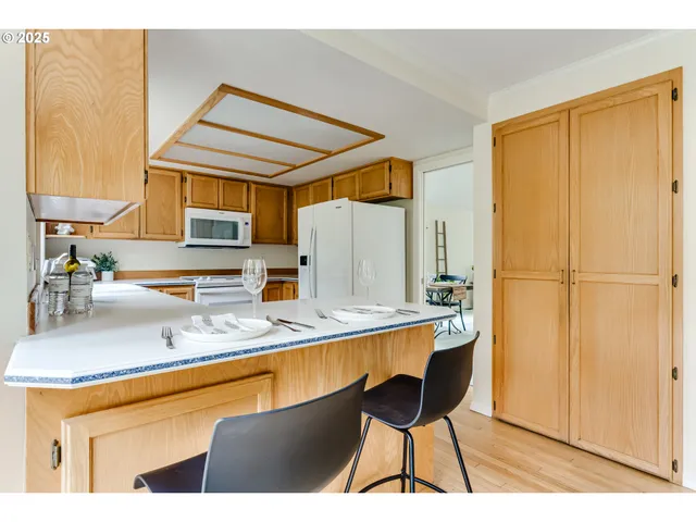 a kitchen with stainless steel appliances granite countertop a sink and a refrigerator