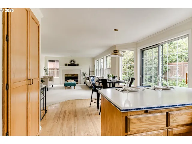 a living room with furniture a fireplace and a chandelier