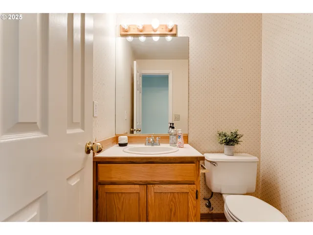 a bathroom with a sink toilet and mirror