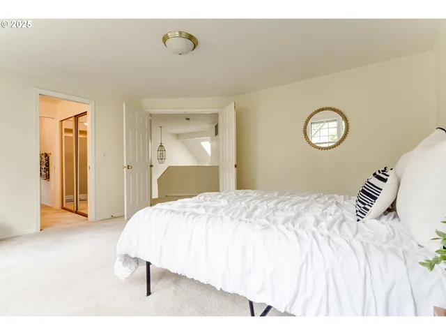 a bedroom with a bed and a lamp