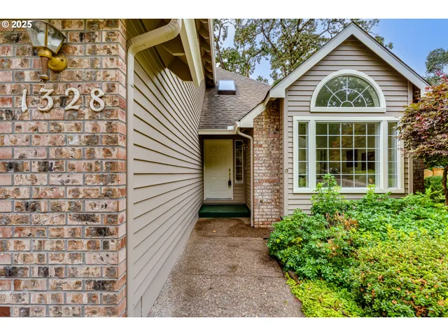 a view of a brick house with a large windows