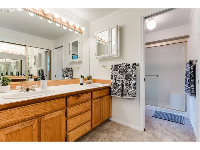 a bathroom with a sink a mirror and a shower