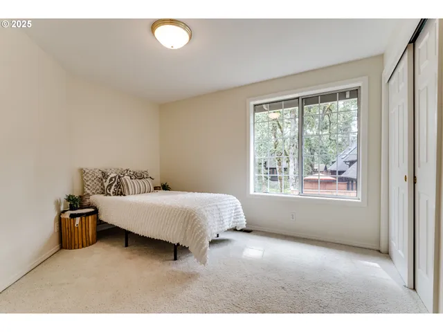 a spacious bedroom with a bed and a window