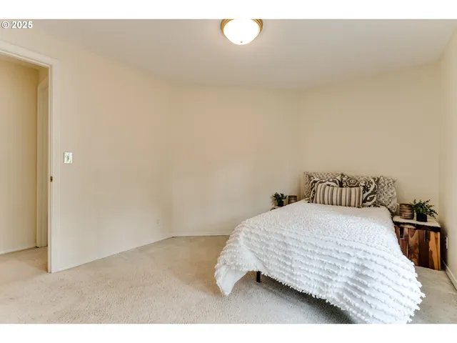 a bedroom with a bed and lamp