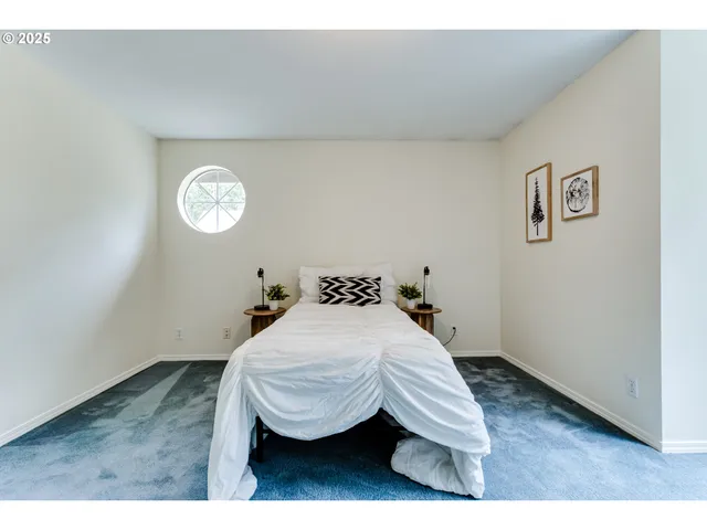 a bedroom with a bed and a wall painting