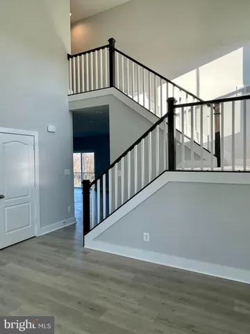 a view of staircase with railing and white walls