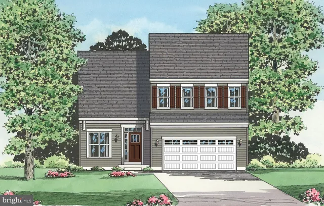 a view of a house with a yard and large tree