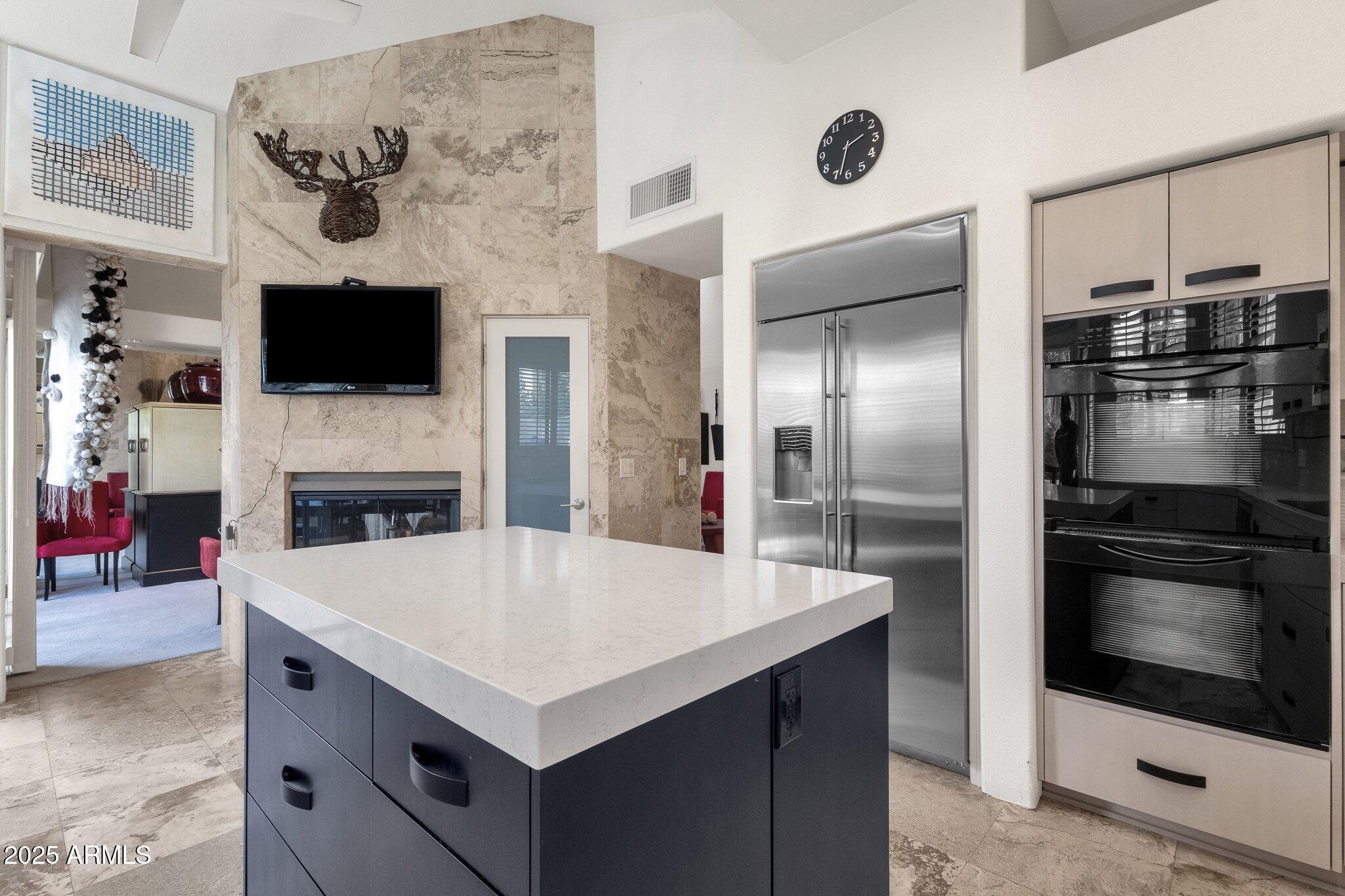 7740 East Gainey Ranch Road, Unit 36 Scottsdale, AZ 85258 - Photo 14 of 54 a kitchen with stainless steel appliances a stove microwave and a refrigerator