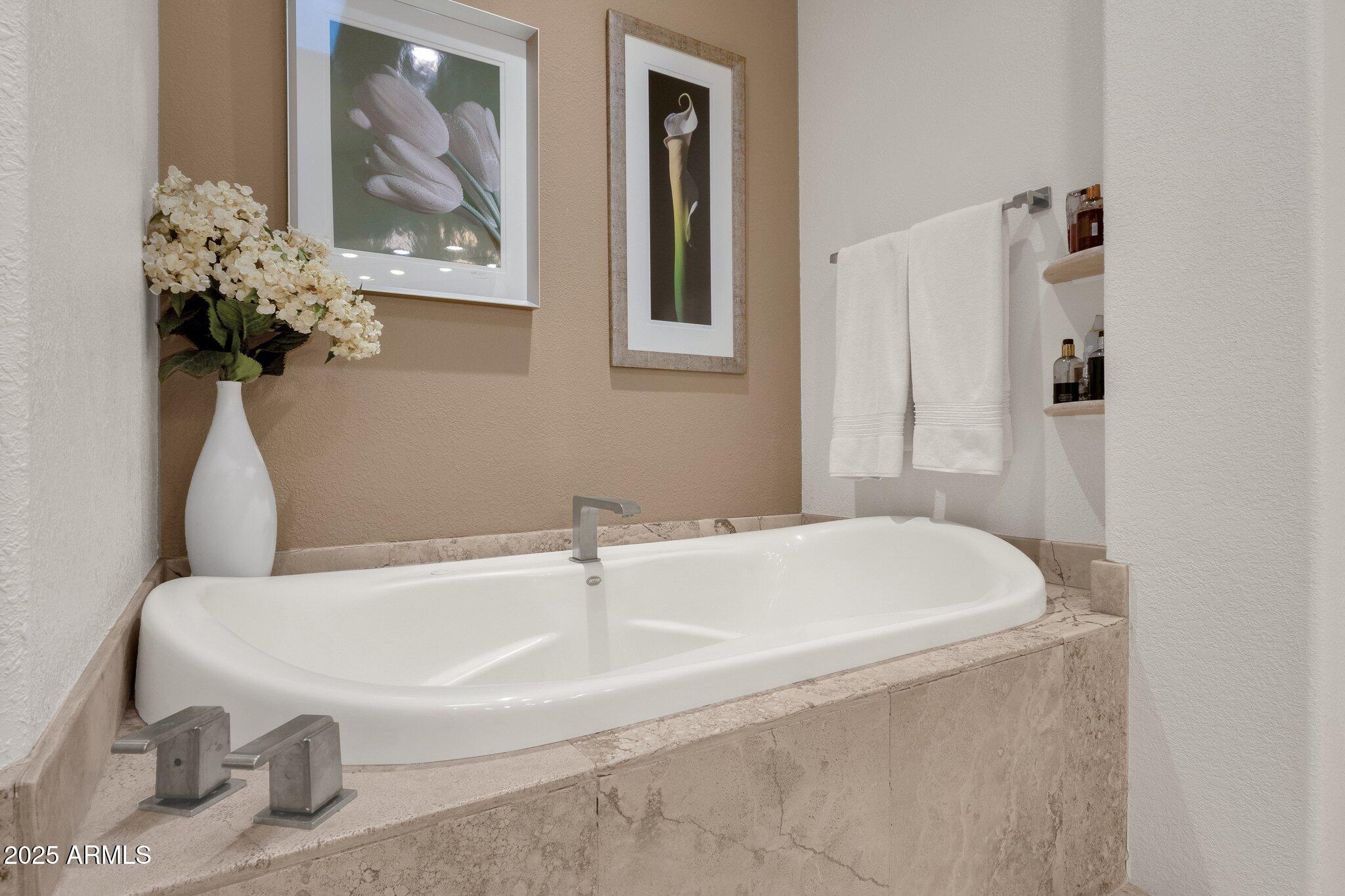 7740 East Gainey Ranch Road, Unit 36 Scottsdale, AZ 85258 - Photo 23 of 54 a white bath tub sitting next to a white sink