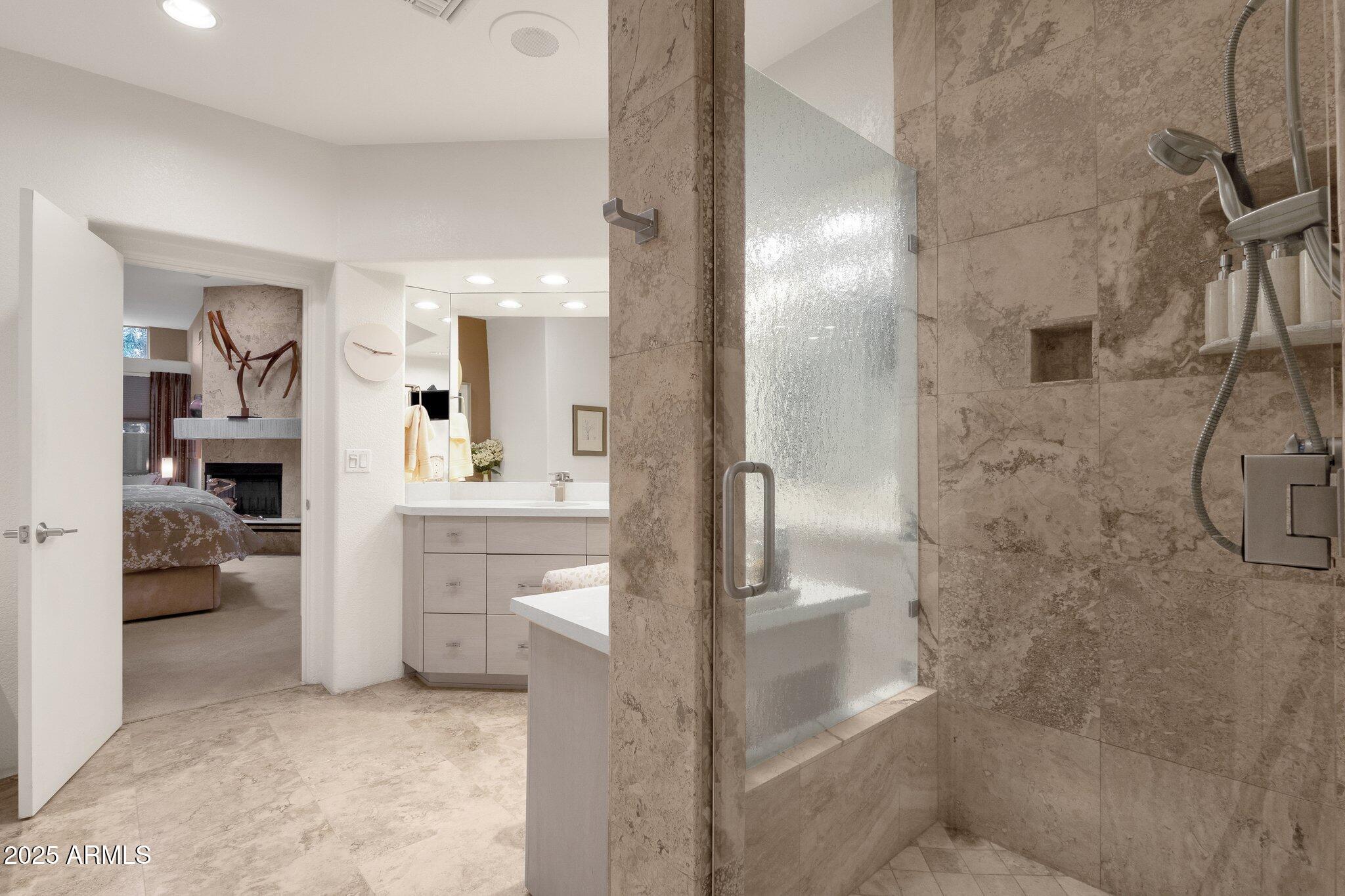 7740 East Gainey Ranch Road, Unit 36 Scottsdale, AZ 85258 - Photo 24 of 54 a bathroom with a double vanity sink a toilet and shower