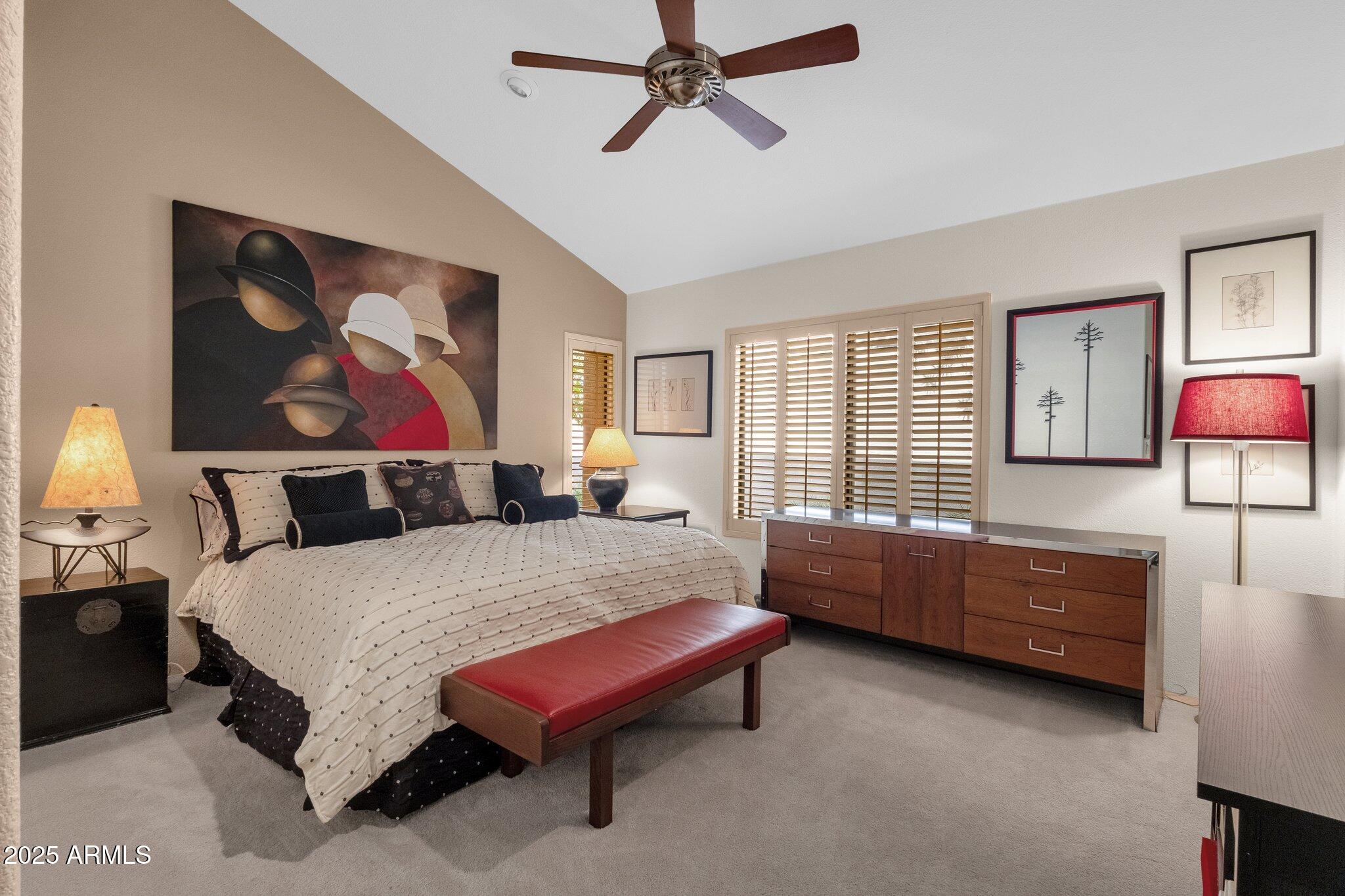 7740 East Gainey Ranch Road, Unit 36 Scottsdale, AZ 85258 - Photo 26 of 54 a bedroom with a bed and a chandelier