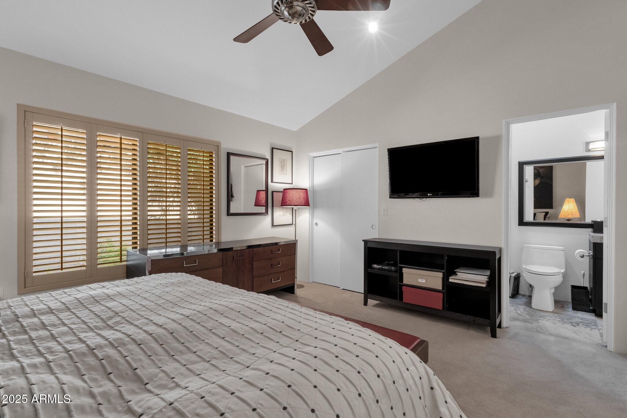7740 East Gainey Ranch Road, Unit 36 Scottsdale, AZ 85258 - Photo 27 of 54 a bedroom with a bed and a television
