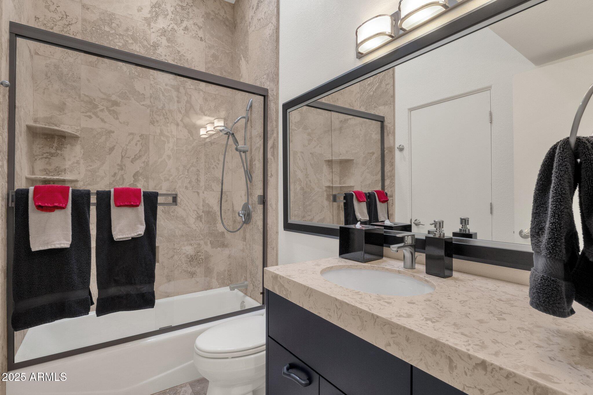 7740 East Gainey Ranch Road, Unit 36 Scottsdale, AZ 85258 - Photo 28 of 54 a bathroom with a sink vanity mirror and toilet