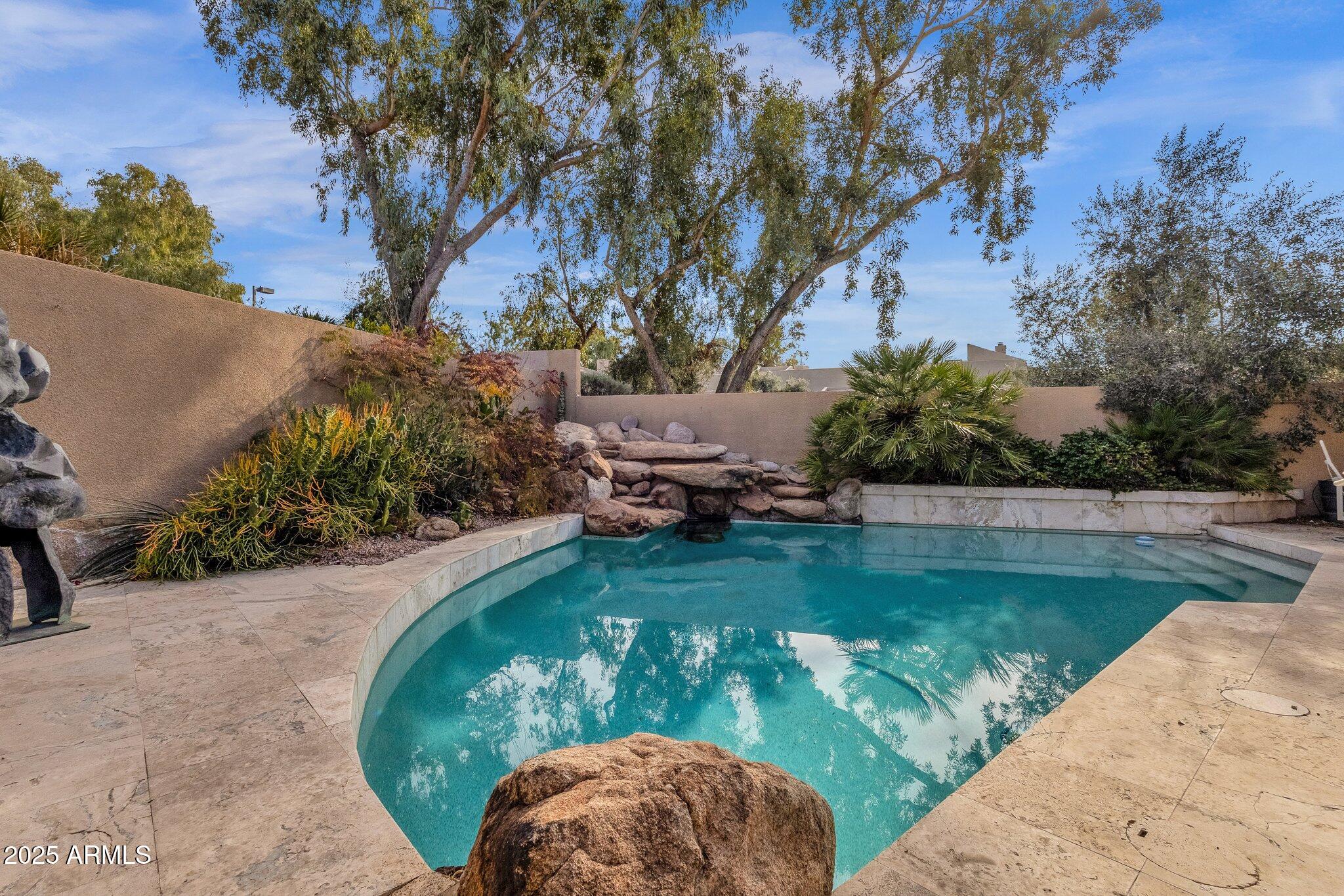 7740 East Gainey Ranch Road, Unit 36 Scottsdale, AZ 85258 - Photo 32 of 54 a view of a swimming pool with a yard