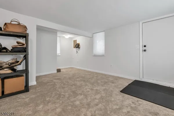 a view of an empty room and closet with window