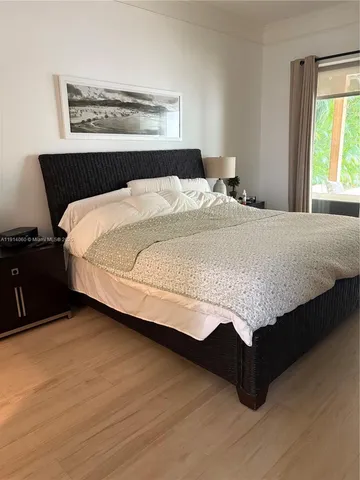 a bedroom with a bed and window