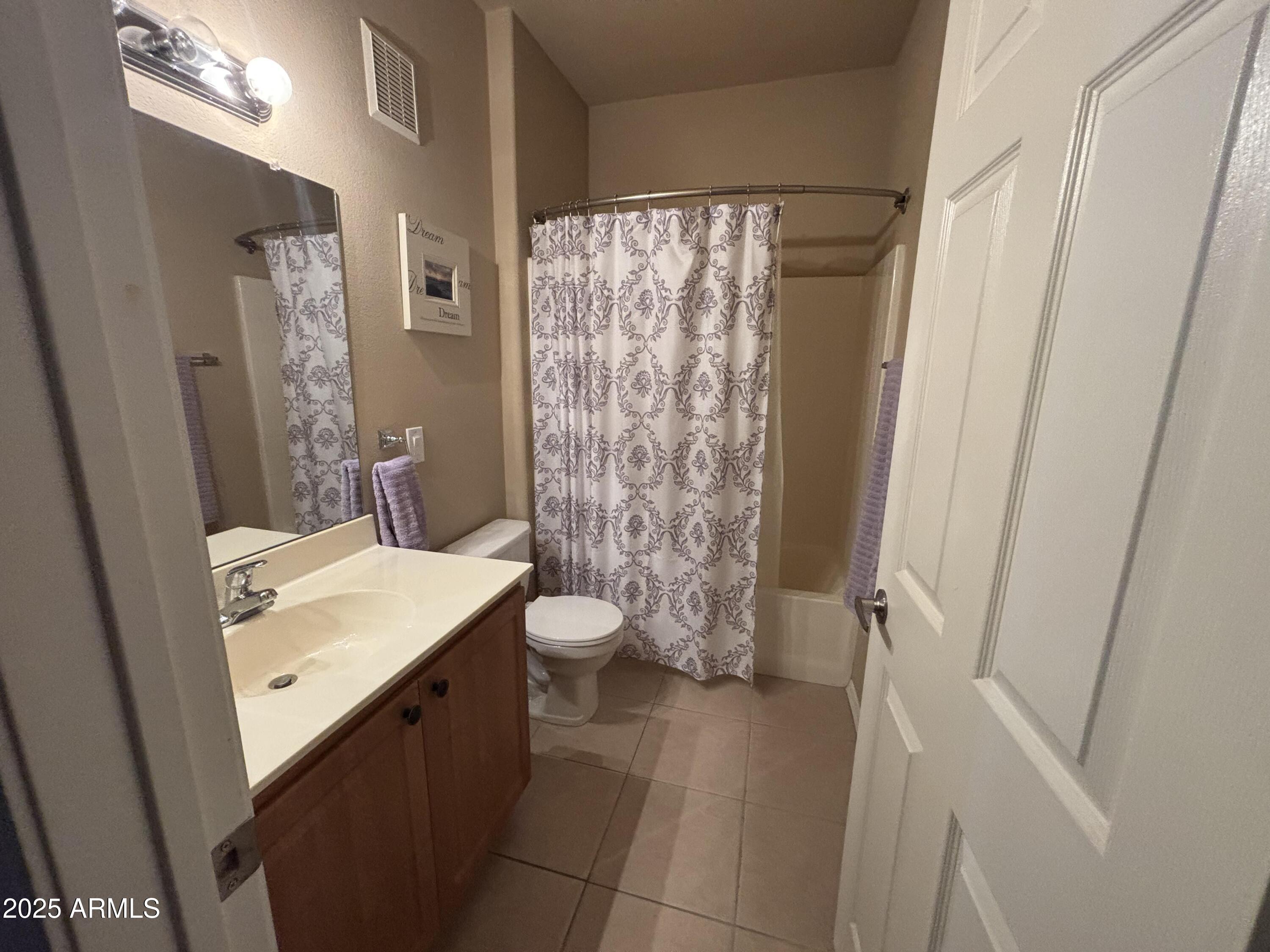 10136 East Southern Avenue, Unit 2048 Mesa, AZ 85209 - Photo 11 of 23 a bathroom with a sink a toilet a mirror and shower